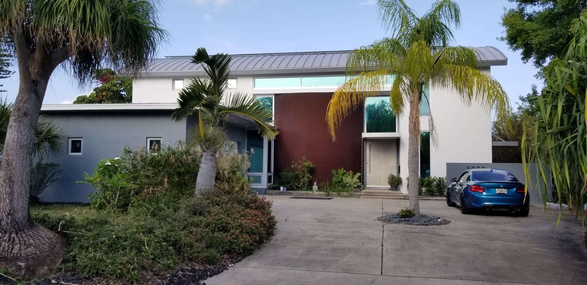 Modern Florida home with freshly painted deep red and slate blue exterior walls